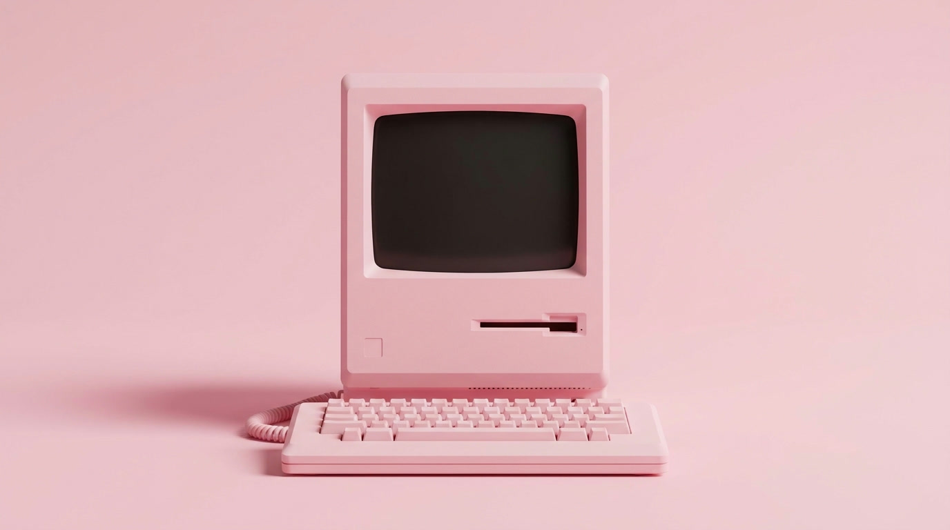 A retro pink computer on a pastel pink background